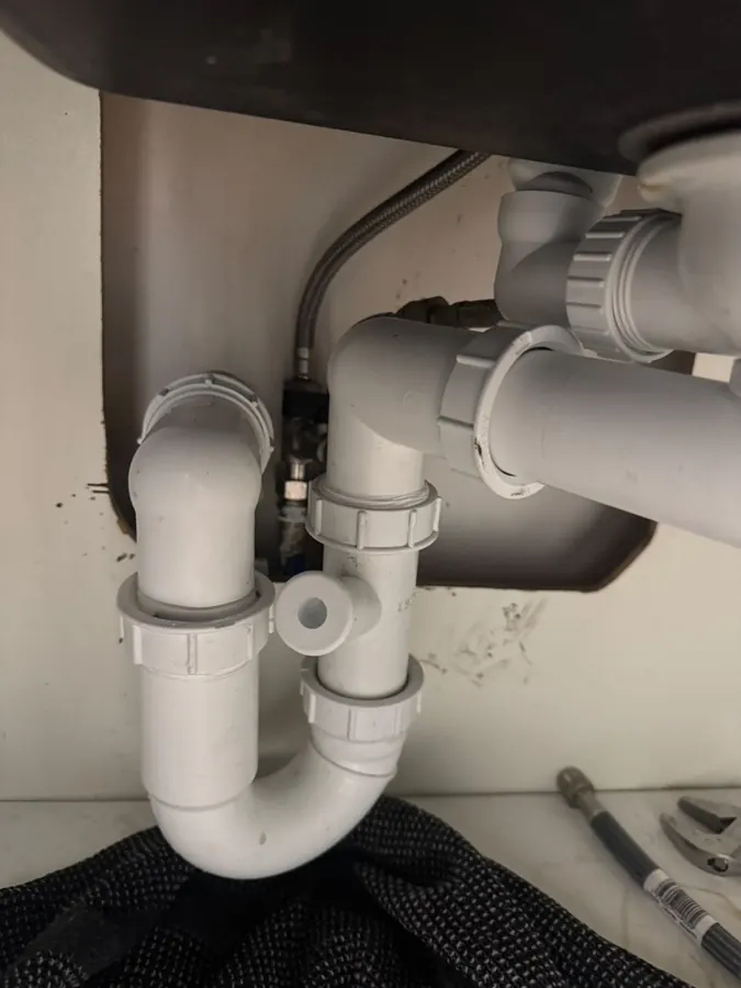 Évacuation d'évier refaite en PVC avec double siphon — plombier Paris 1er